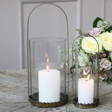 Load image into Gallery viewer, white candle inside antique brass lantern
